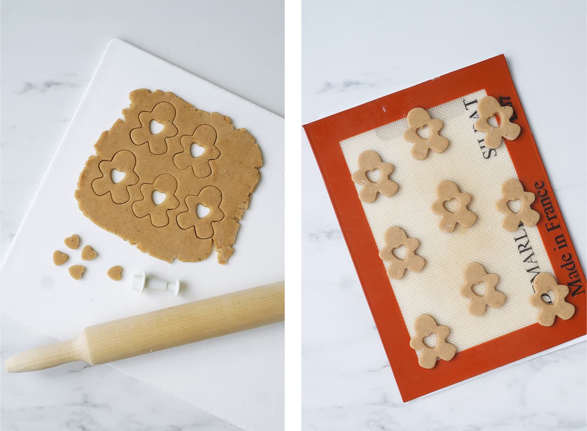 Cookie dough is cutout into shapes of gingerbread men with a cutout of a  heart. 