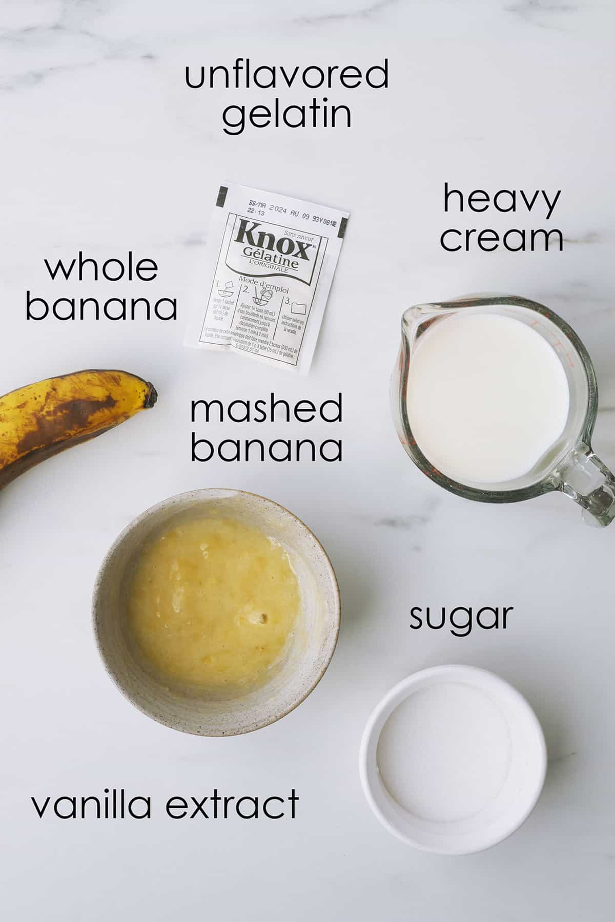 Ingredients to make stabilized fresh banana cream are laid out on a table. 