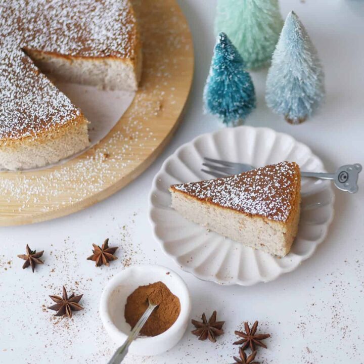 A slice is cut out of a golden brown Japanese gingerbread cheesecake.