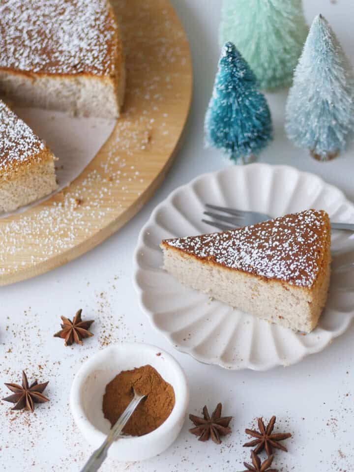 A slice is cut out of a golden brown Japanese gingerbread cheesecake.