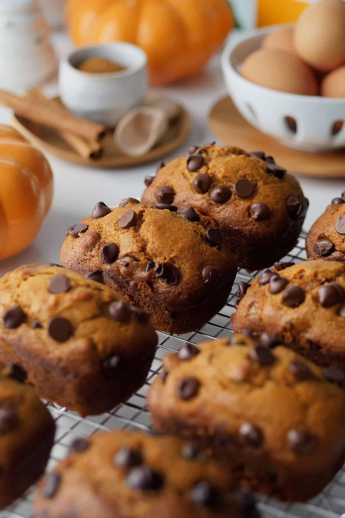 Side close up view of mini pumpkin cake loaves on a cooling rack. 